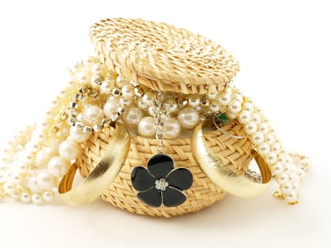 Basket full of jewelery, towards white background