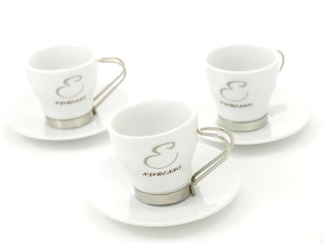 Espresso coffee cups, on plates, towards white