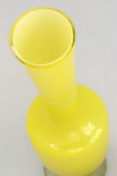 yellow vase over a grey background