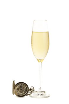 cold glass of champagne with a old pocket watch on white background