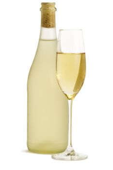 glass of champagne in front of standing dull prosecco bottle on white background