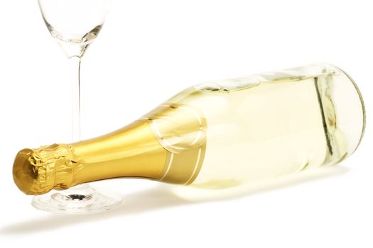 lying champagne bottle with a empty champagne glass on white background