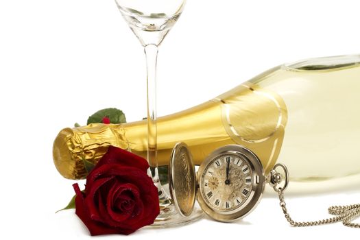 wet red rose under a champagne bottle with a old pocket watch and a empty champagne glass on white background