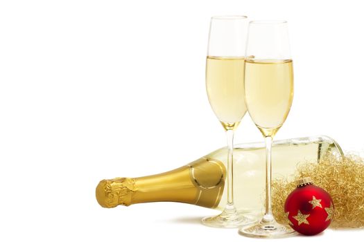 two glasses of champagne with angels hair, red christmas ball in front of a champagne bottle on white background