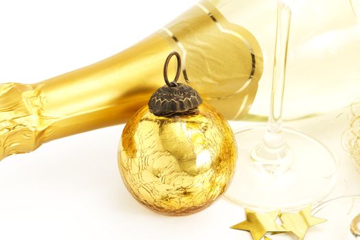 a golden vintage christmas ball with bottom of a champagne glass and a champagne bottle on white