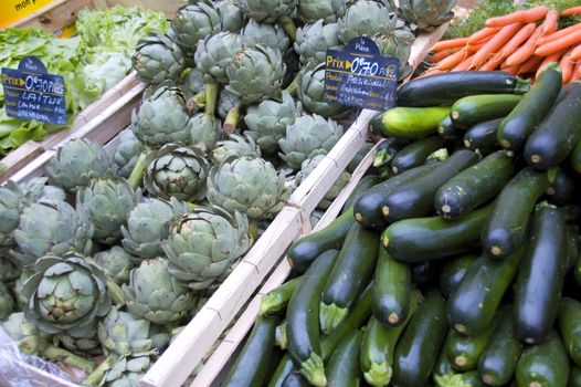 French vegetable market with artichokes, zucchini and salad.