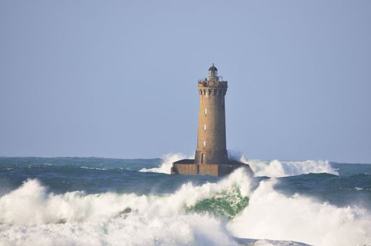 Lighthouse called "Le phare du four" in Tremazan in Brittany, France during storm in November