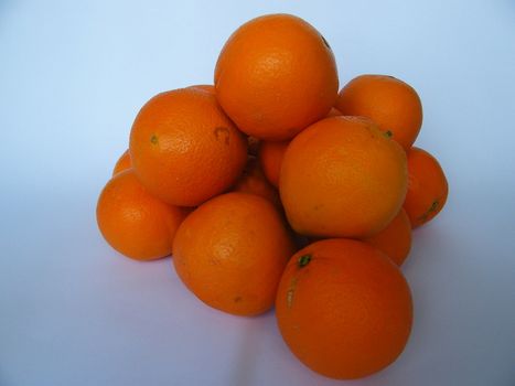 A lot of coloured oranges on white background