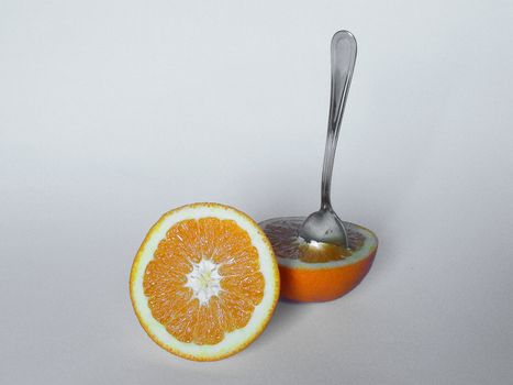 An orange on white table ready to eat