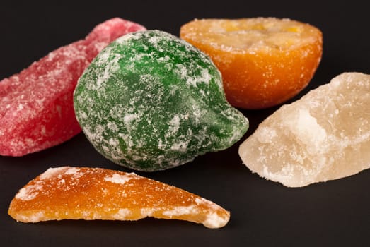 Closeup of assorted candied fruit on black