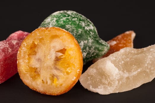 Closeup of assorted candied fruit on black