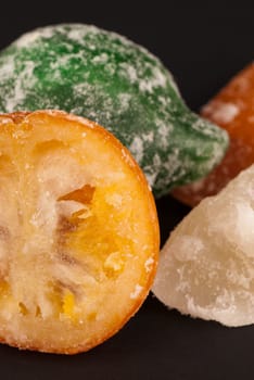 Closeup of assorted candied fruit on black