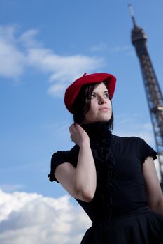 girl wearing a red beret and the eiffel tower