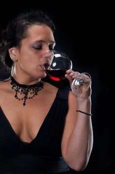 beatiful lady in an elegant dress drinking red wine