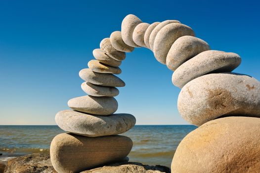 Arch of the white pebbles on the sea coast