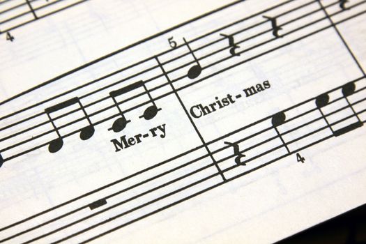 Merry Christmas text on a sheet of music.