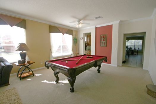 A Pool Table in a room in a house