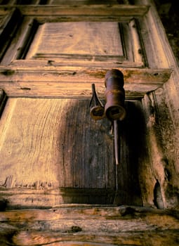 An old wooden door with a rusted handle.