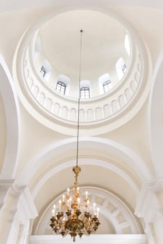 Interior detail with golden chandelier. Public space
