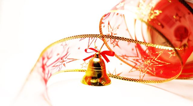 Christmas bell toy with red ribbon on white