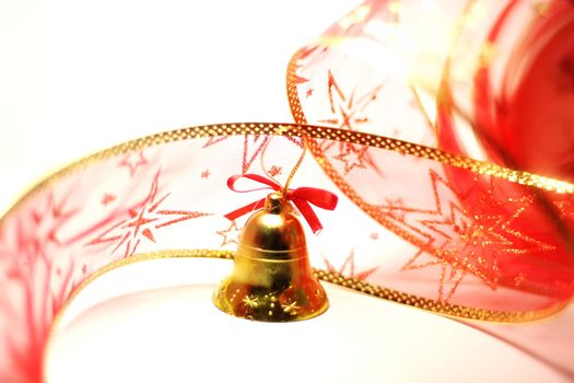 Christmas bell toy with red ribbon on white