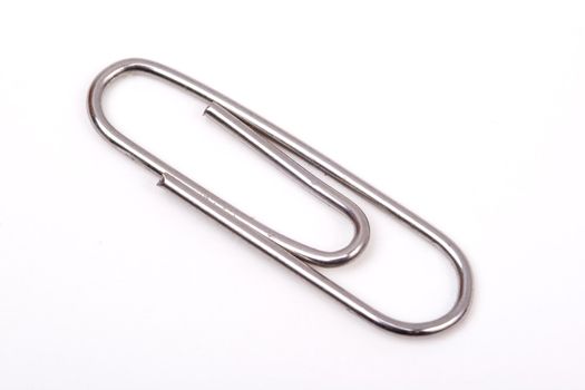 A metal paperclip on a white background