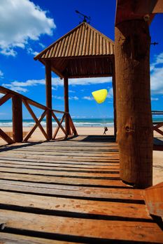 Footbridge of access to Cortadura's beach in Cádiz and paraglider