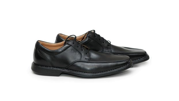 Classic men's black club shoe, isolated wide angle macro closeup
