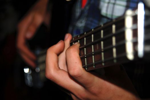 Hands Playing Electric Bass Guitar