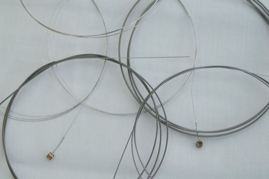 Set of Metal Guitar Strings on White background