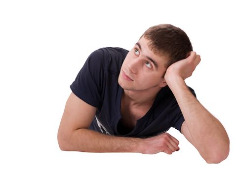Thoughtful young man lying on isolated white