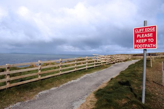 a warning sign of danger at the cliff edge walk