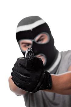 An angry looking man aiming a handgun at the viewer. Works great for crime or home security concepts.