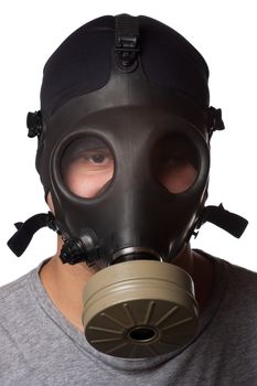 A young man wears a gas mask isolated over a white background.