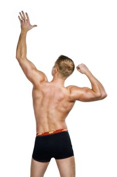 Shirtless bodybuilder posing against white background