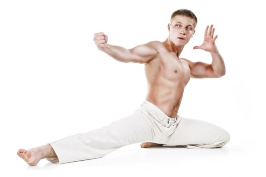 Kickboxer throws a punch, isolated on white background.