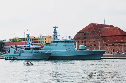 Two big military boats anchored in harbour dock