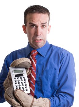 Concept image of an economy in trouble featuring a young banker holding onto his calculator with oven mitts, isolated against a white background