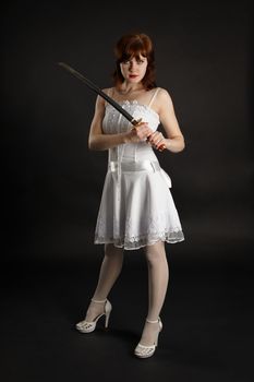 Young beautiful girl armed with a sword