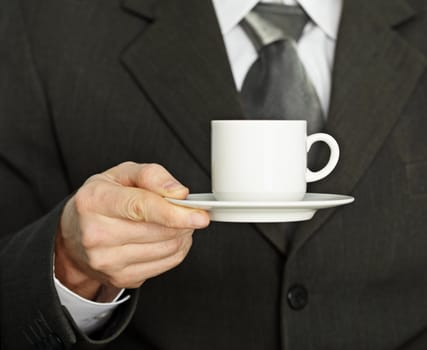 Porcelain coffee cup in hand, a businessman - a break from work