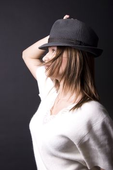 Portrait of a young seductive brunette in hat