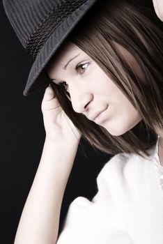 Portrait of a young seductive brunette in hat