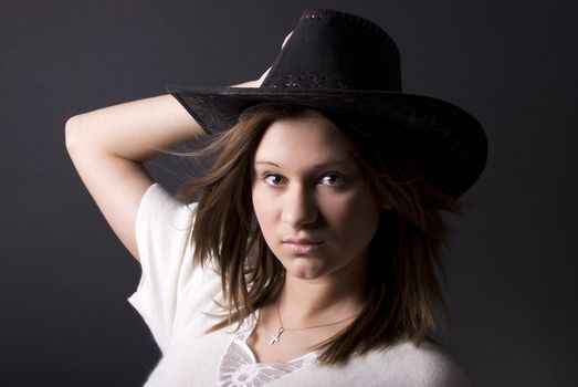 Portrait of a young seductive cowgirl