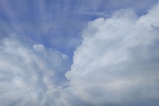 Rays of light shining through cumulonimbus clouds      