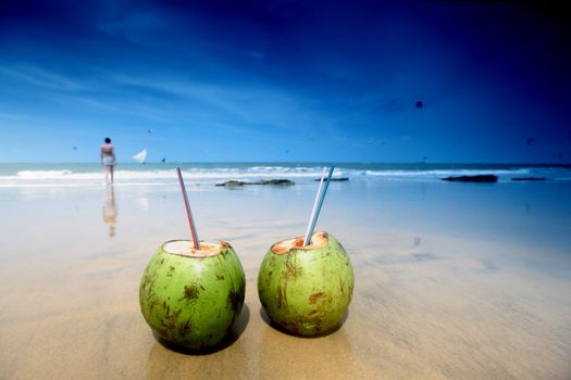 coconut cocktail on beach sand