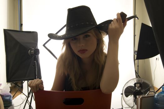 young sexy cowgirl posing with poor indoors