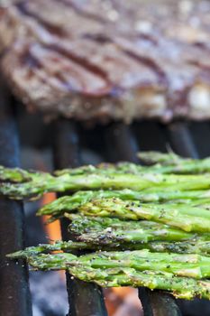 steak and asparagus on a charcoal grill short focus