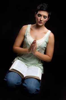 Religious praying woman reading bible