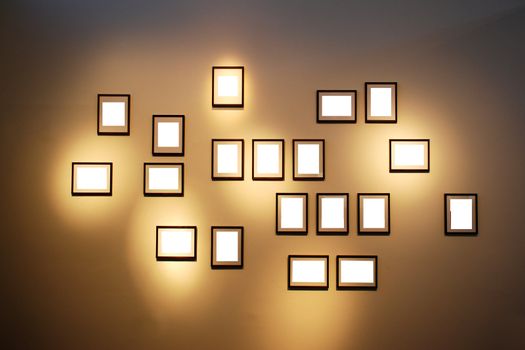 Blank white frames with a copy space area on a brown wall