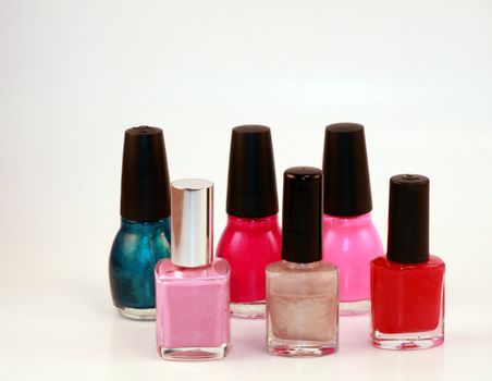 Women's beauty cosmetic for hands. Fingernail polish bottles in a variety of bright colors. Beauty, fashion and cosmetics for women.